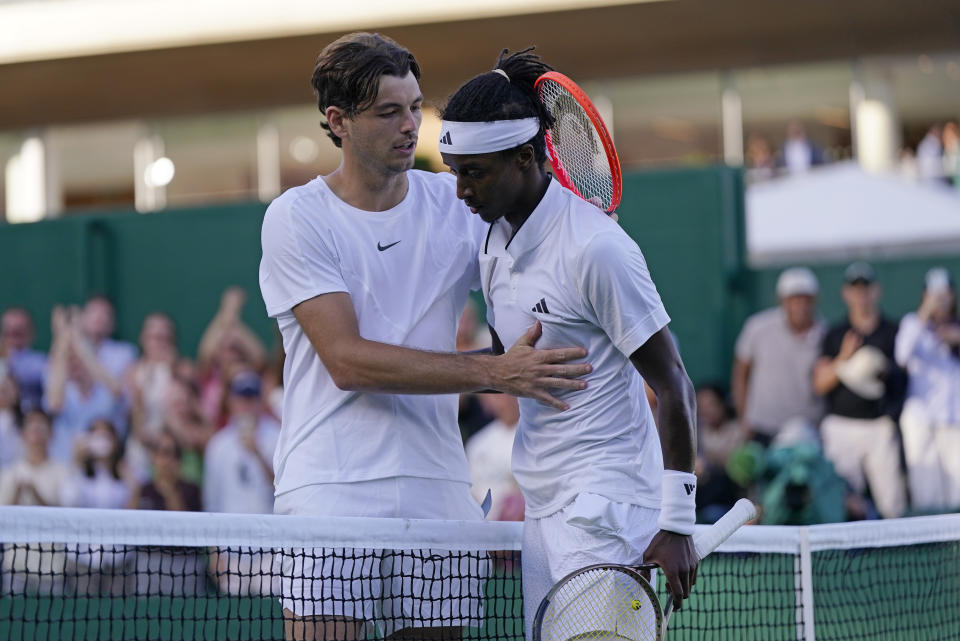 Sweden's Mikael Ymer, right, greets Taylor Fritz of the US at the net after beating him in a men's singles match on day four of the Wimbledon tennis championships in London, Thursday, July 6, 2023. (AP Photo/Alberto Pezzali)