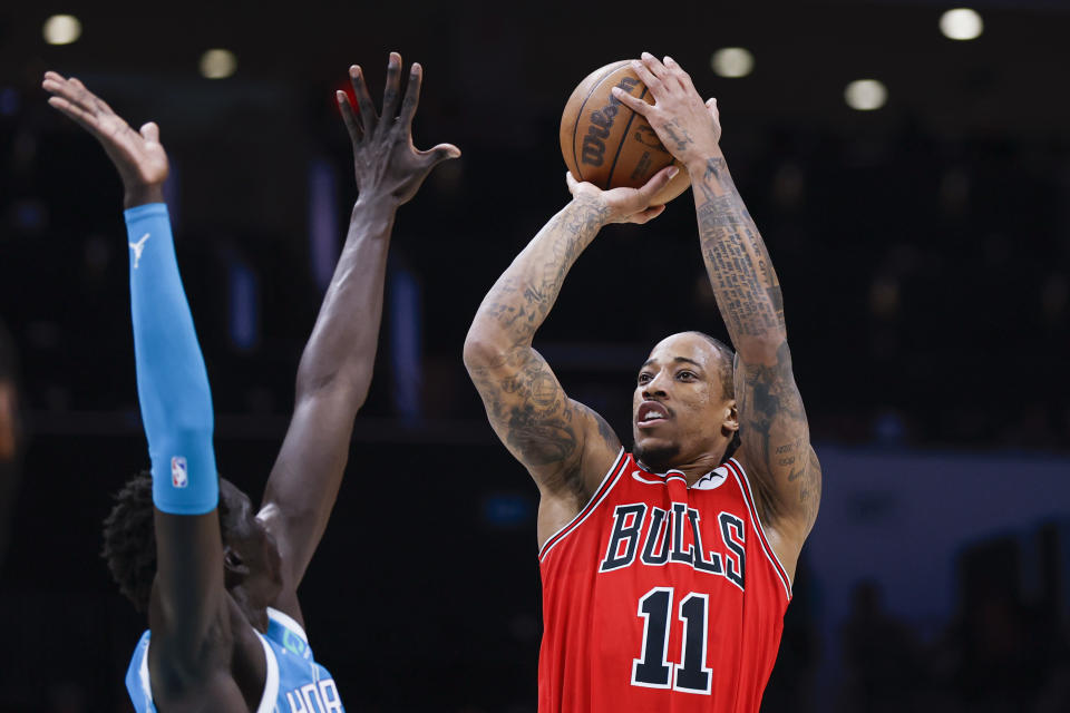 Chicago Bulls forward DeMar DeRozan (11) shoots over Charlotte Hornets forward JT Thor during the first half of an NBA basketball game in Charlotte, N.C., Friday, March 31, 2023. (AP Photo/Nell Redmond)