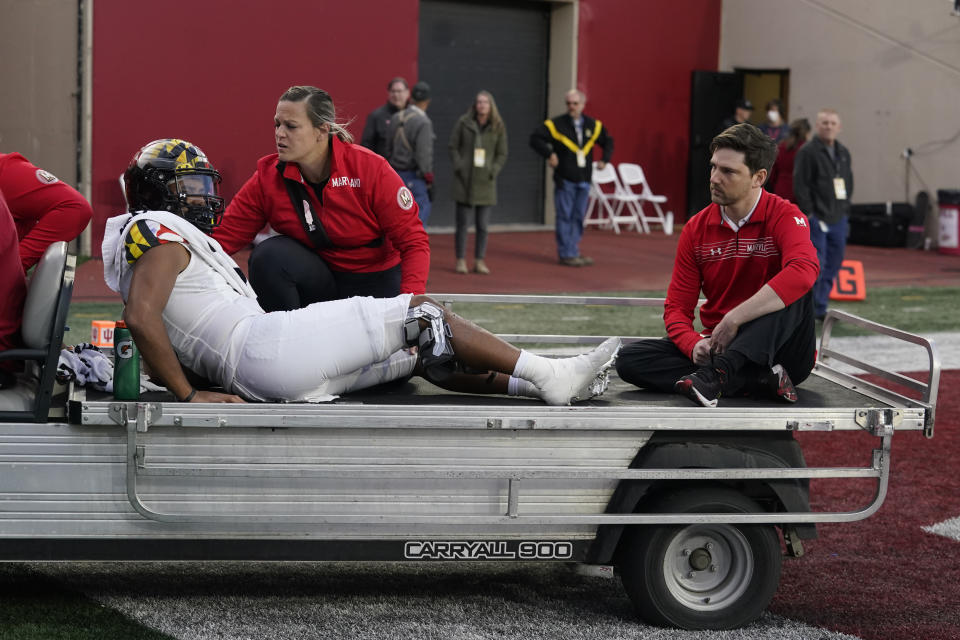 Maryland quarterback Taulia Tagovailoa, left, is carted off the field during the second half of an NCAA college football game against Indiana, Saturday, Oct. 15, 2022, in Bloomington, Ind. (AP Photo/Darron Cummings)