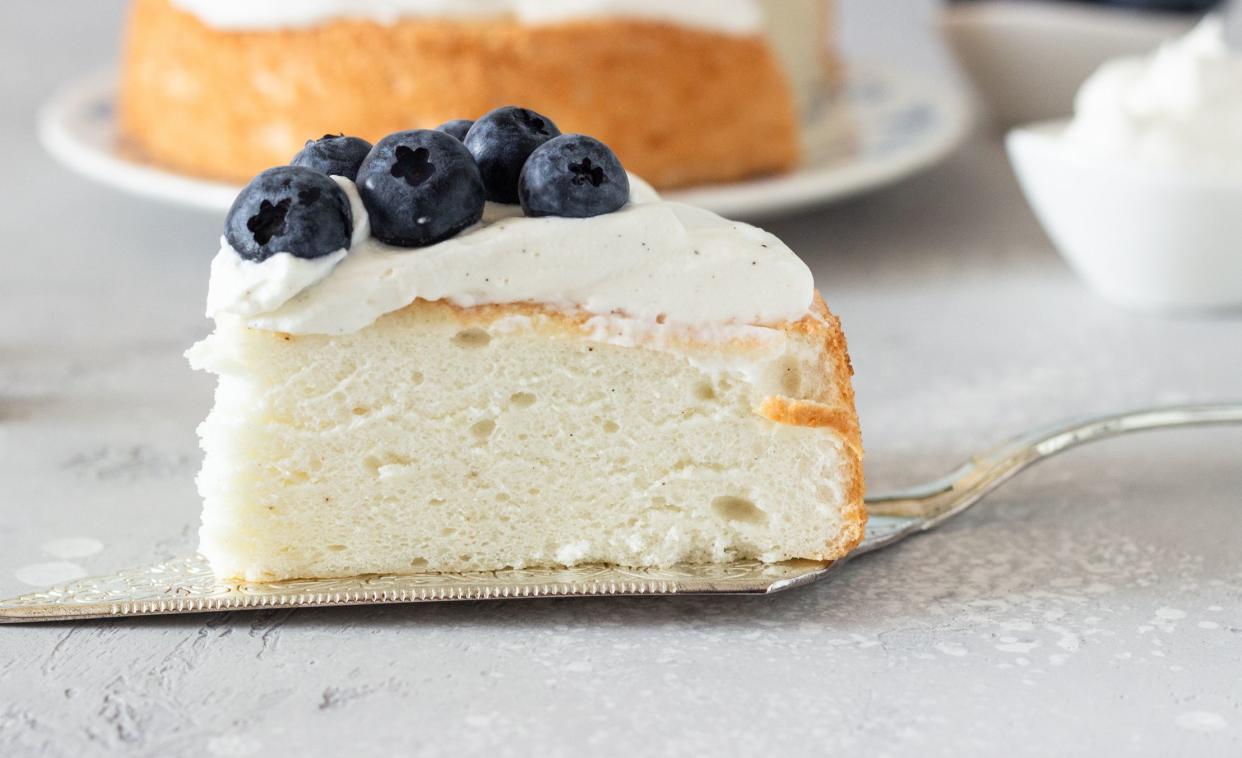 Angel food cake with whipped cream and blueberries.