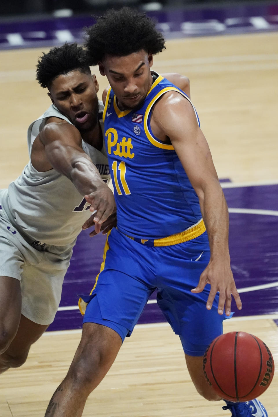 Pittsburgh guard/forward Justin Champagnie, right, drives against Northwestern guard Anthony Gaines during the first half of an NCAA college basketball game in Evanston, Ill., Wednesday, Dec. 9, 2020. (AP Photo/Nam Y. Huh)