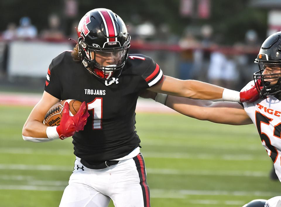 Eli Aston runs with the ball during the Skyline Chili Crosstown Showdown against Lawrenceburg at East Central High School on Friday, Aug. 19, 2022.