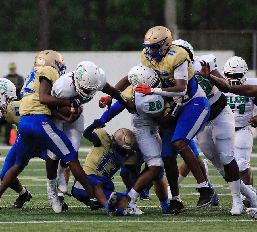 Mainland defensive lineman LJ McCray (11) pursues DeLand's TJ Moore (5) during the first quarter, Friday, Aug. 26, 2022.