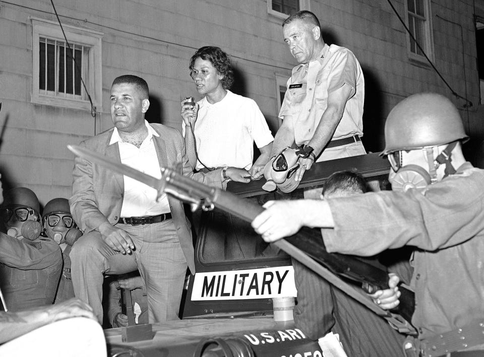 FILE - In this May 11, 1964, file photo, masked National Guardsman with their bayonets held at the ready surround the jeep of Brig. Gen. George Gelson, head of the guard unit, as Stanley Branche, chairman of the Committee for Freedom Now, left, and Gloria Richardson, second from left, stands beside him in Cambridge, Md. Richardson, an influential yet largely unsung civil rights pioneer whose determination not to back down while protesting racial inequality was captured in a photograph as she pushed away the bayonet of a National Guardsman, died Thursday, July 15, 2021, in New York, according to Joe Orange, her son in law. She was 99. (AP Photo/William Smith, File)