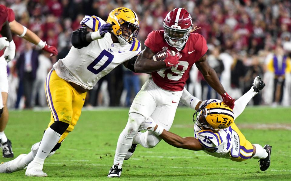 Alabama wide receiver Kendrick Law (19) is tackled by LSU defensive tackle Maason Smith (0) and safety Sage Ryan (15) on Nov. 4, 2023, in Tuscaloosa, Ala.