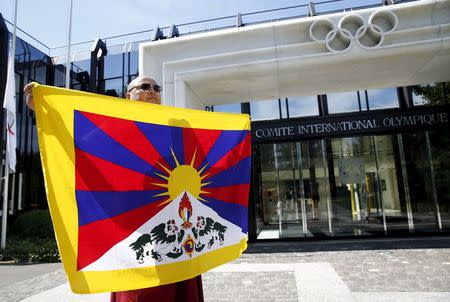 Tibetan monk Golog Jigme protests against the designation of Beijing for the Winter Olympics Games 2022 in front of the International Olympic Committee (IOC) in Lausanne, Switzerland, in this July 31, 2015 file photo. REUTERS/Denis Balibouse/Files