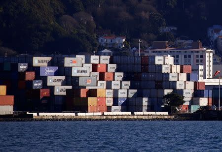 Houses and apartment blocks can be seen behind containers stacked on a dock in Wellington, New Zealand, July 2, 2017. REUTERS/David Gray/Files