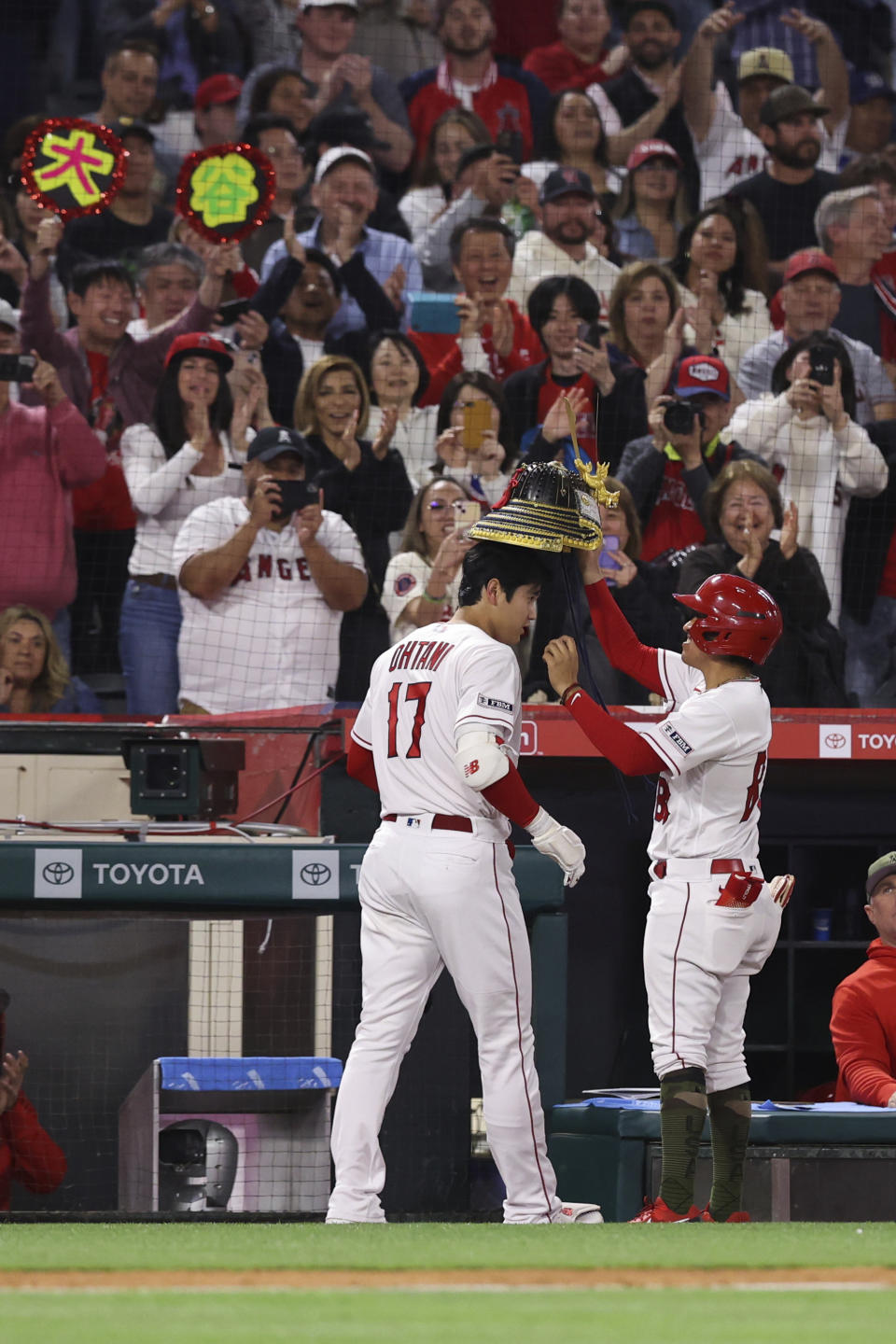 Los Angeles Angels designated hitter Shohei Ohtani (17) celebrates with the bat boy after hitting a home run during the sixth inning of a baseball game against the Minnesota Twins in Anaheim, Calif., Saturday, May 20, 2023. (AP Photo/Jessie Alcheh)