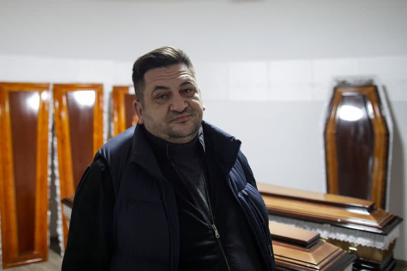 Funeral home owner Sebastian Cocos poses for a portrait in the funeral home he runs, in Ploiesti