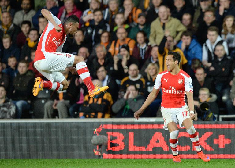 Arsenal's midfielder Francis Coquelin (L) celebrates Alexis Sanchez's goal during the English Premier League football match between Hull City and Arsenal in Hull on May 4, 2015
