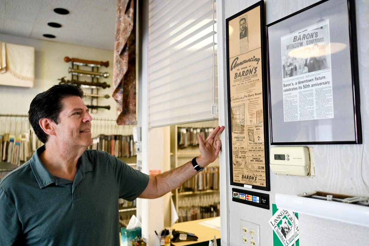 Neil Baron, owner of Baron's Window Coverings, talks about a newspaper advertisement for the store's grand opening in 1944 on Thursday, Sept. 21, 2023, in downtown Lansing.