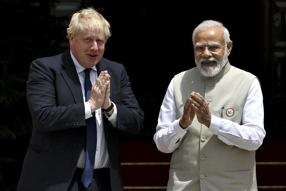 Britain's Prime Minister Boris Johnson, left, and his Indian counterpart Narendra Modi gesture before their meeting at Hyderabad House in New Delhi Friday, April 22, 2022. (Ben Stansall/Pool Photo via AP)