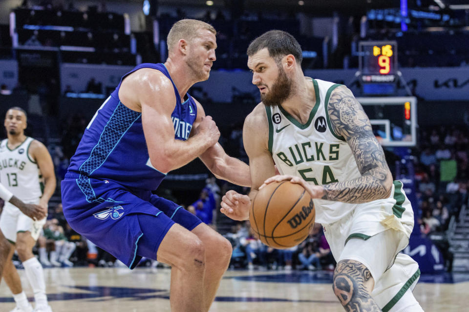 Charlotte Hornets center Mason Plumlee, left, defends against Milwaukee Bucks forward Sandro Mamukelashvili (54) during the first half of an NBA basketball game Saturday, Dec. 3, 2022, in Charlotte, N.C. (AP Photo/Scott Kinser)