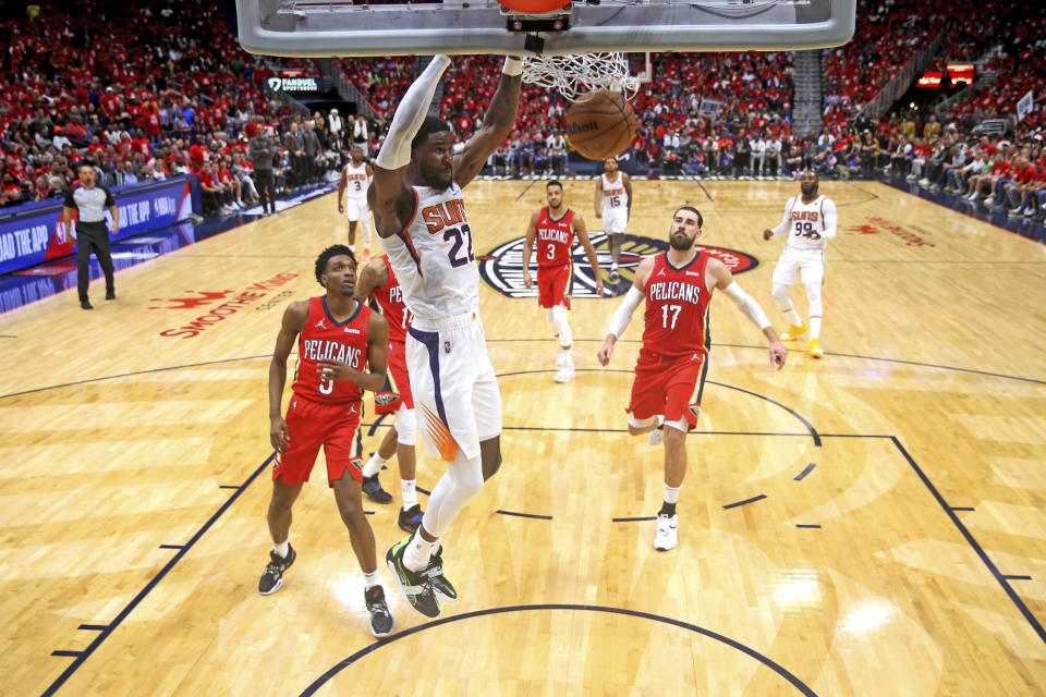 Phoenix Suns center Deandre Ayton (22) dunks against the New Orleans Pelicans during the first half of Game 3 of an NBA basketball first-round playoff series in New Orleans, Friday, April 22, 2022. (AP Photo/Michael DeMocker)