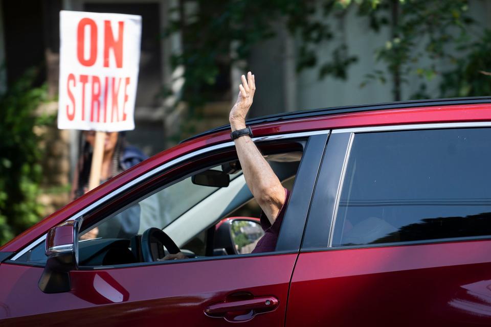 Teachers and other Columbus Education Association union members and supporters march up and down Henderson Road outside of Whetstone High School on Tuesday, the second day of the strike.