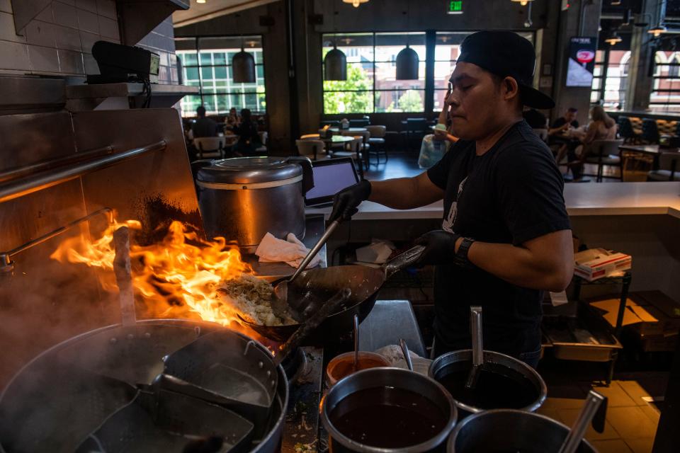 Miguel Torres prepares a dish at Thai Esane inside at Assembly Food Hall  in Nashville , Tenn., Monday, May 29, 2023.