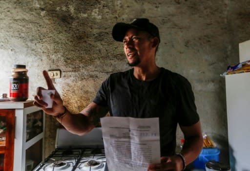 Nicaraguan basketball player Carlos Silva, who was released from jail the day before to complete his sentence at home, shows his trophies at his house in Managua on February 28, 2019