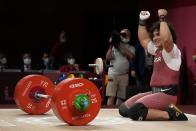 Fares Ibrahim Elbach of Qatar celebrates after winning the gold medal in the men's 81kg weightlifting event, at the 2020 Summer Olympics, Saturday, July 31, 2021, in Tokyo, Japan. (AP Photo/Luca Bruno)