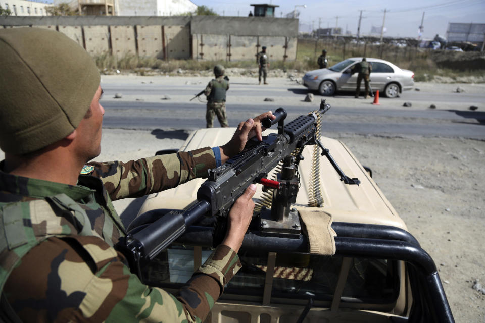 Afghan National army soldiers search a car at a checkpoint ahead of parliamentary elections scheduled for Oct. 20, at the Independent Election Commission compound in Kabul, Afghanistan, Wednesday, Oct. 17, 2018. (AP Photo/Rahmat Gul)