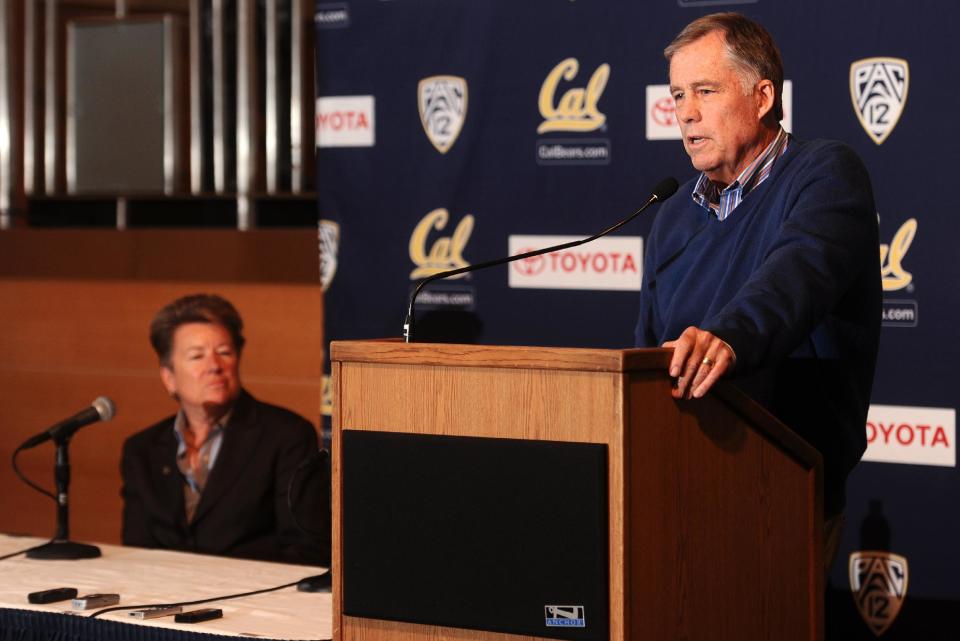 Mike Montgomery, head coach of the California basketball team, discusses his retirement during a news conference Monday, March 31, 2014, in Berkeley, Calif. At left is athletics director Sandy Barbour. (AP Photo/Noah Berger)