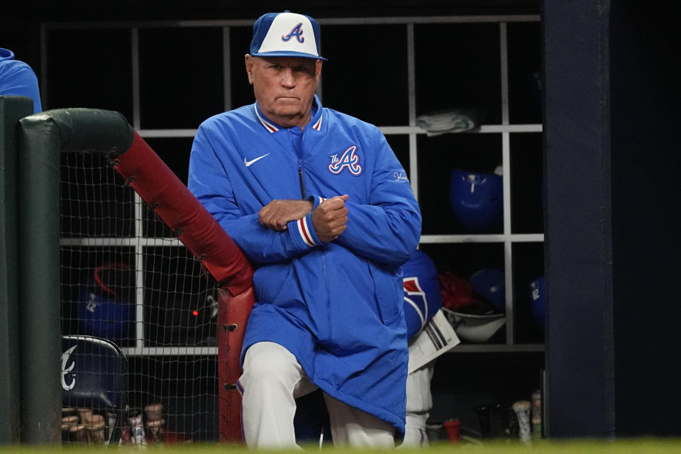 Atlanta Braves manager Brian Snitker watches from the dugout during the team's baseball game against the San Diego Padres, Saturday, April 8, 2023, in Atlanta. (AP Photo/John Bazemore)