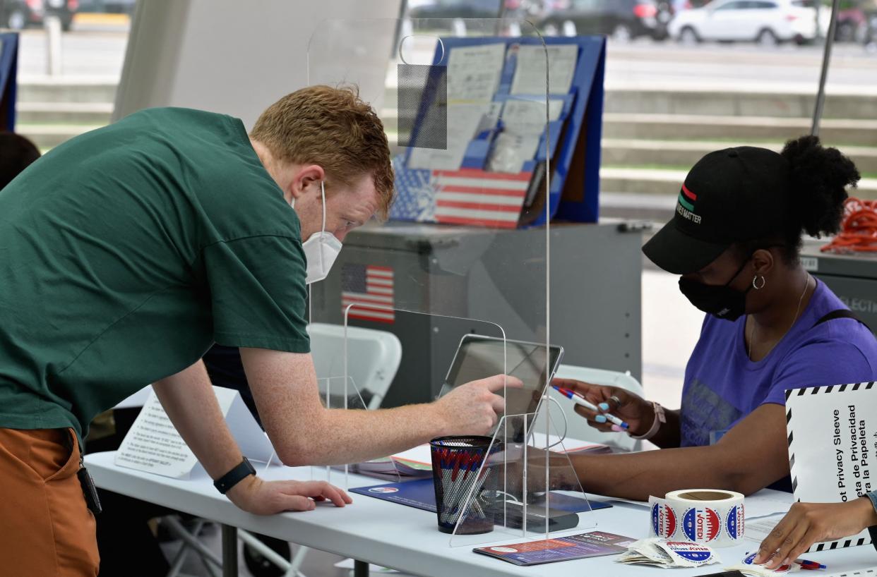 A resident checks in to vote during the New York City mayoral primary election at the Brooklyn Museum polling station on June 22, 2021 in New York City.