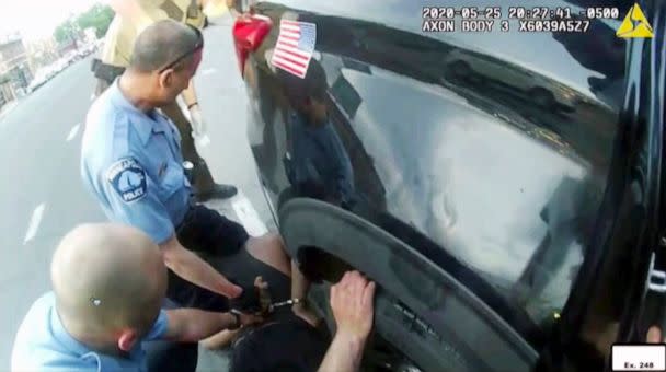 PHOTO: In this image from police body camera video shown as evidence in court, paramedics arrive as Minneapolis police officers, including Derick Chauvin, second from left, and J. Alexander Kueng restrain George Floyd in Minneapolis on May 25, 2020. (Minneapolis Police Department via AP)