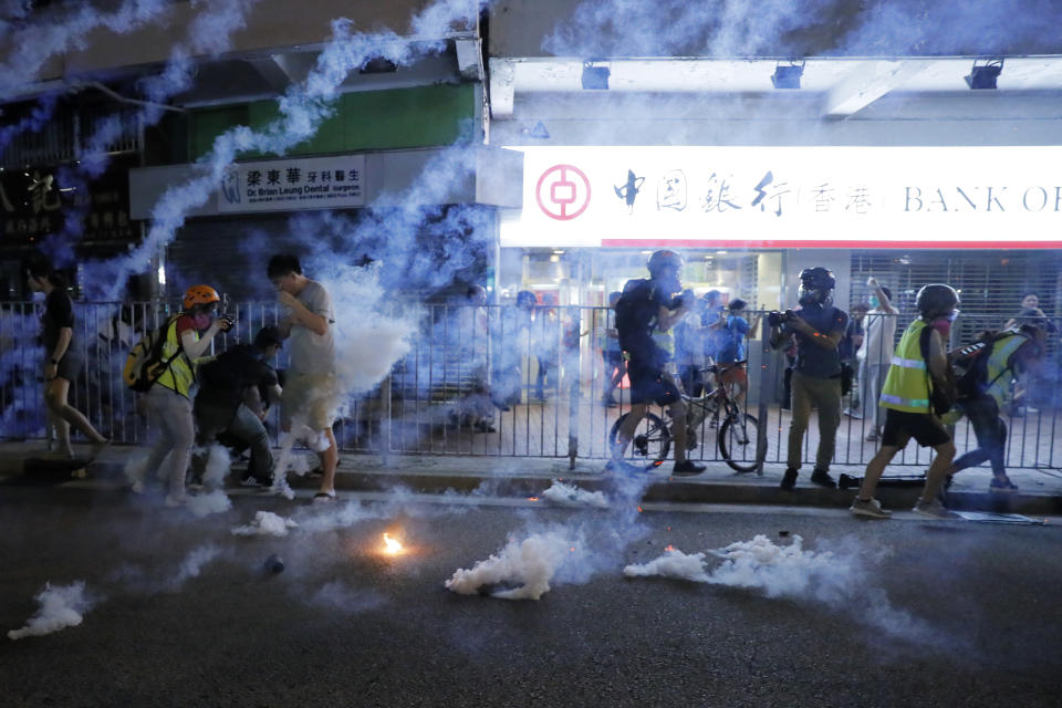 Tear fas fills the street as protesters continue to battle with police on the streets of Hong Kong on Saturday, Sept. 21, 2019. Protesters in Hong Kong threw gasoline bombs and police fired tear gas Saturday in renewed clashes over anti-government grievances (AP Photo/Kin Cheung)