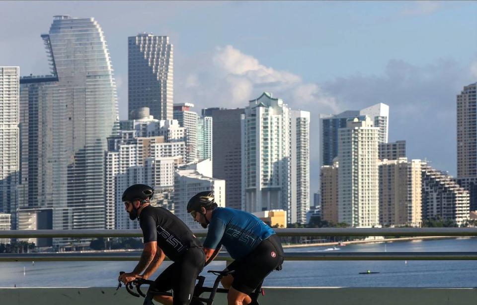 Many cities experienced rent drops or stabilization in South Florida, countering the trend of up to triple-digit increases seen during the pandemic. Above: Cyclists ride over the Rickenbacker Causeway with Brickell in the distance.