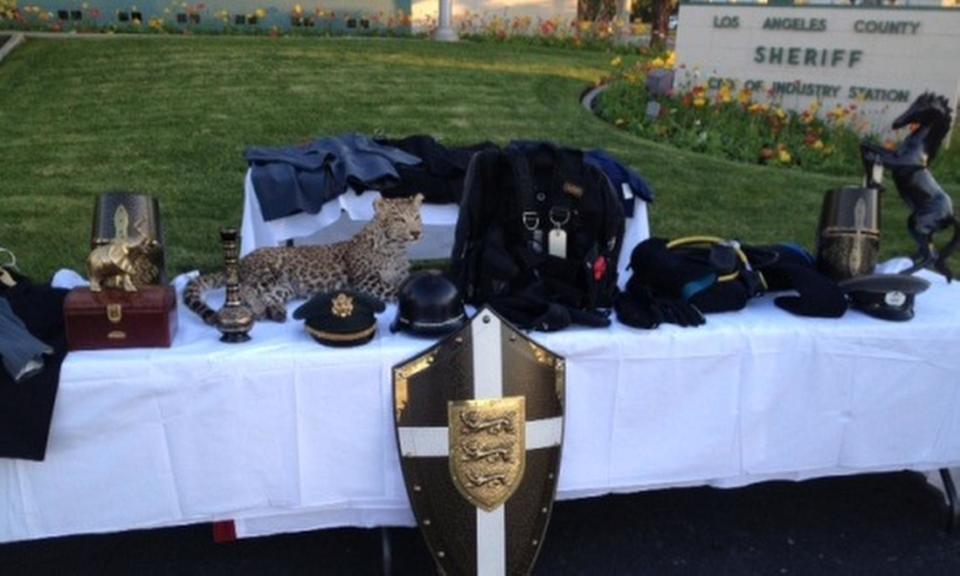 This Dec. 11, 2013 photo provided by the Los Angeles County Sheriff's Department shows recovered stolen items, including designer suits, medieval armor, jewelry, and a mounted snow leopard on display at news conference at Industry Sheriff’s Station in City of Industry, Calif. Authorities have filed criminal charges against 14 teenagers who allegedly broke into a Southern California mansion while the owner was gone and held a party that caused more than $1 million in damage and losses. Los Angeles County prosecutors announced the charges Tuesday, March 18, 2014. Authorities say the party, promoted on social media, sent more than 100 teens to the mansion in La Habra Heights last November. The teens face misdemeanor and felony charges ranging from trespassing to burglary and theft. (AP Photo/Los Angeles County Sheriff's Department)
