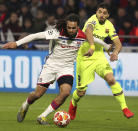 Barcelona forward Luis Suarez, right, challenges Lyon defender Jason Denayer, left, during the Champions League round of 16 first leg soccer match between Lyon and FC Barcelona in Decines, near Lyon, central France, Tuesday, Feb. 19, 2019. (AP Photo/Laurent Cipriani)