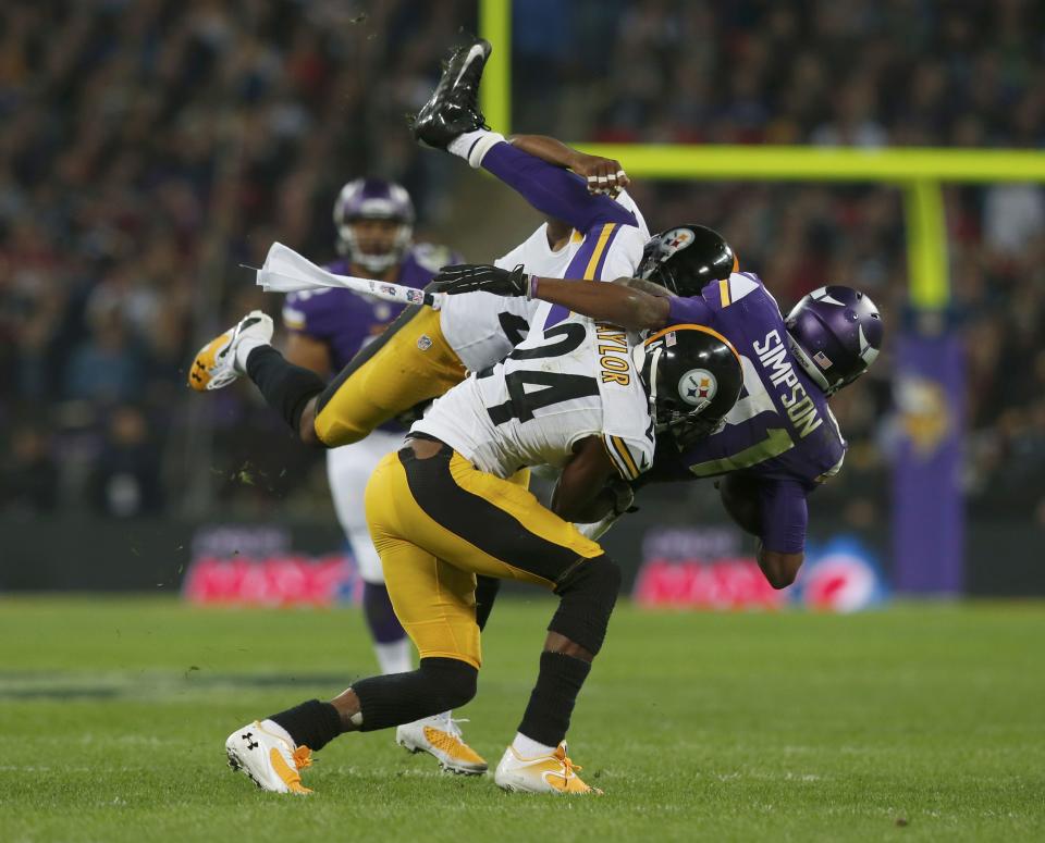 Minnesota Vikings wide receiver Simpson is brought down by Pittsburgh Steelers cornerback Taylor and another defender in the second quarter during their NFL football game at Wembley Stadium in London