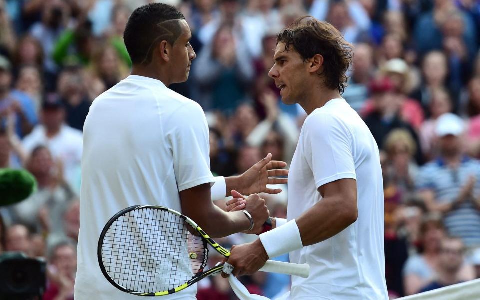 Australia's Nick Kyrgios (L) shakes hands with Spain's Rafael Nadal (R) after Kyrgios won their men's singles fourth round match against on day eight of the 2014 Wimbledon Championships at The All England Tennis Club - CARL COURT/AFP via Getty Images