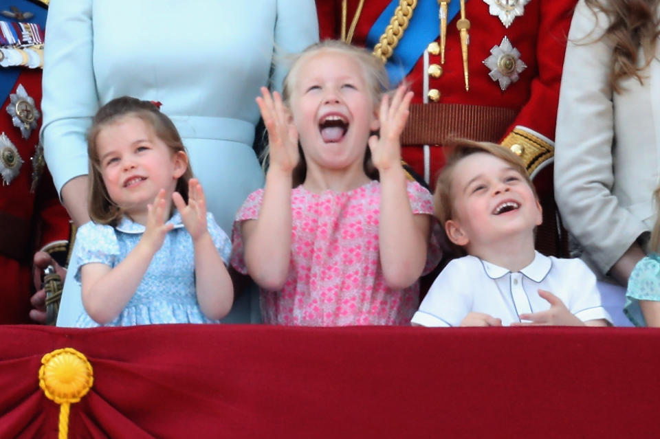 Princess Charlotte, Savannah Phillips, and Prince George watch the flypast on the balcony of Buckingham Palace during Trooping The Colour on June 9, 2018, in London, England.