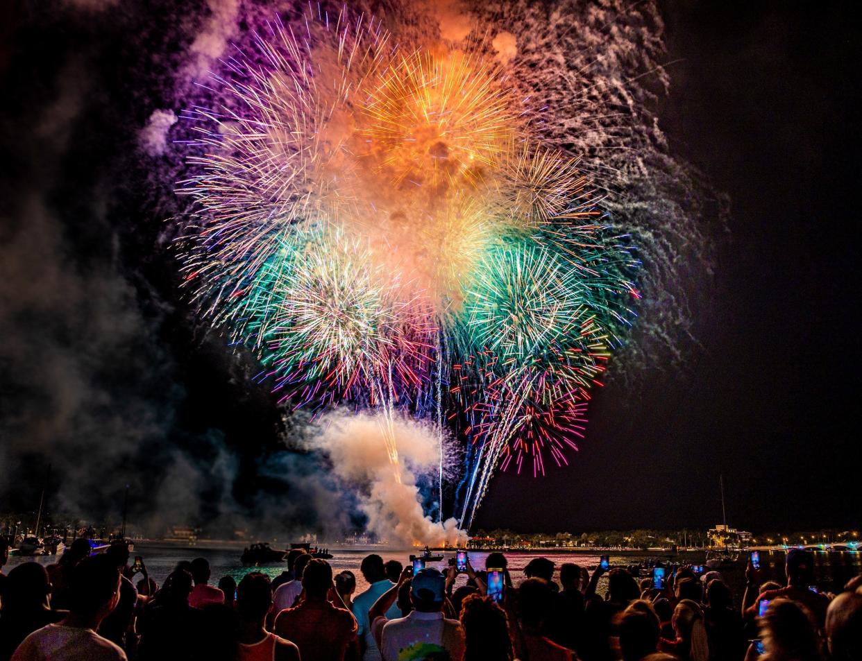 Crowds gather along the waterfront for a view of the fireworks during the 4th on Flagler celebration in downtown West Palm Beach, Florida on July 4, 2021.   