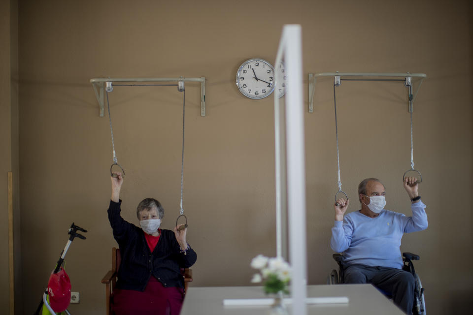 Residents wearing face masks to protect against the spread of coronavirus make exercise at DomusVi nursing home in Leganes, Spain, Wednesday, March 10, 2021. (AP Photo/Manu Fernandez)