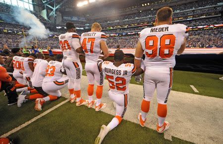 Sep 24, 2017; Indianapolis, IN, USA; The Cleveland Browns team stand and kneel during the National Anthem before the start of their game against the Indianapolis Colts at Lucas Oil Stadium. Mandatory Credit: Thomas J. Russo-USA TODAY Sports