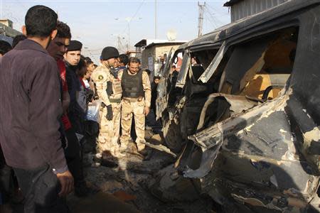 Iraqi security forces inspect the site of car bomb attack in Baghdad's Sadr city December 8, 2013. REUTERS/Wissm al-Okili