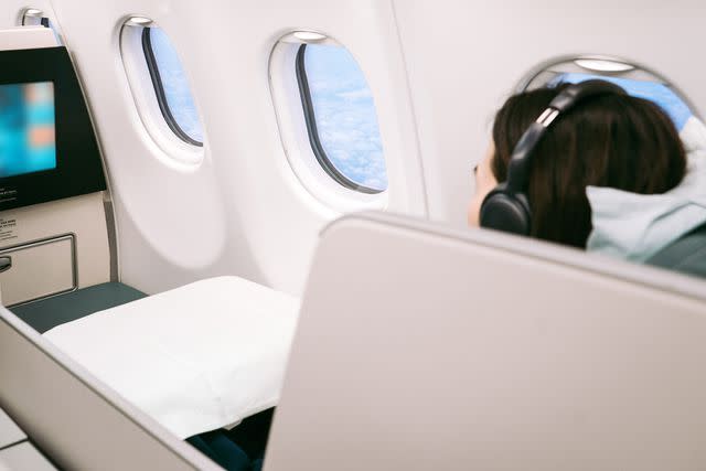 <p>Getty</p> A stock image of a woman on an airplane.