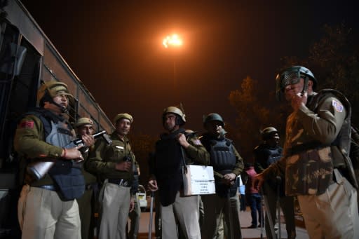 Police stand guard following clashes between supporters and opponents of a new citizenship law in New Delhi