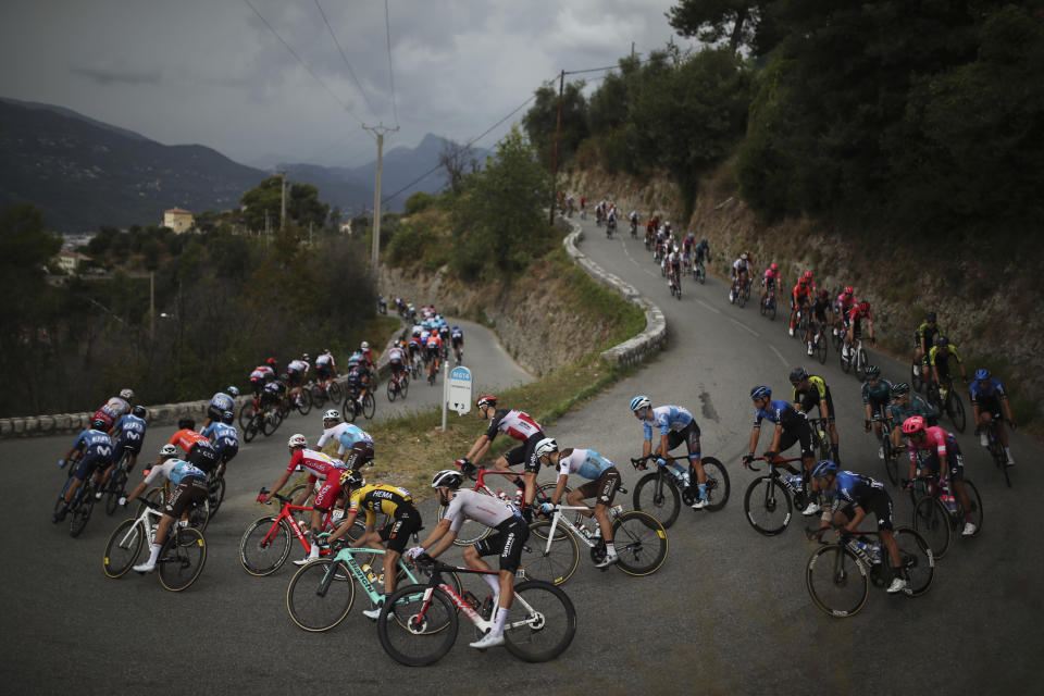 The pack rides during the first stage of the Tour de France cycling race over 156 kilometers (97 miles) with start and finish in Nice, southern France, Saturday, Aug. 29, 2020. (AP Photo/Daniel Cole)