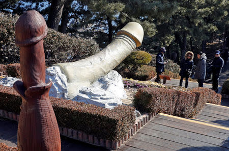 Tourists look at statues in the Penis Park (Reuters)