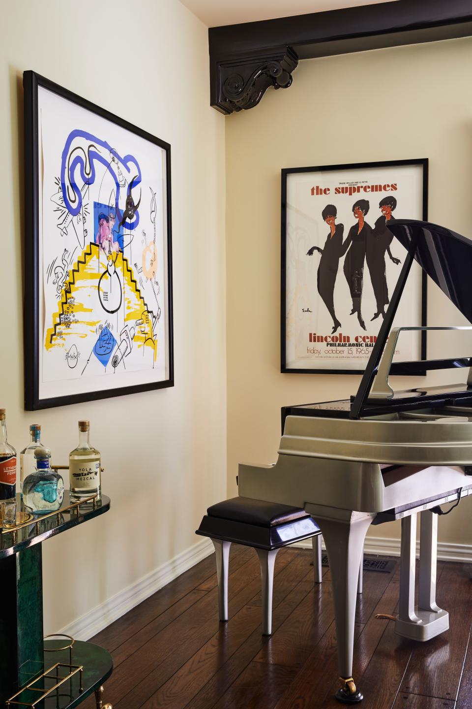 This vintage 1940s Rippen piano—made from aluminum specifically for use aboard cruise ships (lightweight and moisture-resistant)—is more than pure ornament. When Ronson isn’t playing it, the piano has a built-in player that entertains. The drawing on the left is by Keith Haring. “He’s forever linked with my memories of living in New York,” says Ronson. “It was a fairly inexpensive print, and maybe the first thing I ever bought—when I was 25 and DJing in New York.” The poster to the right is an announcement for the Supremes’ sold-out one-night-only concert at Lincoln Center in the fall of 1965.