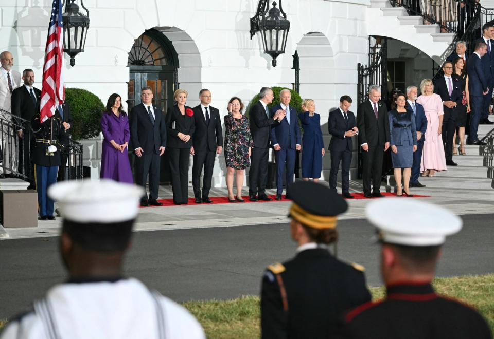 US President Joe Biden (C) and guests watch an honor guard march as he and First Lady Jill Biden host a dinner with NATO Allies and partners at the White House in Washington, DC, on July 10, 2024 on the sidelines of the NATO 75th anniversary summit. (Photo by SAUL LOEB / AFP) (Photo by SAUL LOEB/AFP via Getty Images)