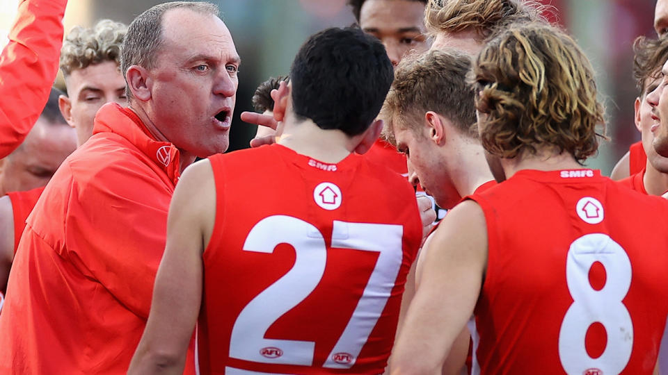 Sydney Swans coach John Longmire speaks to the team during quarter time.