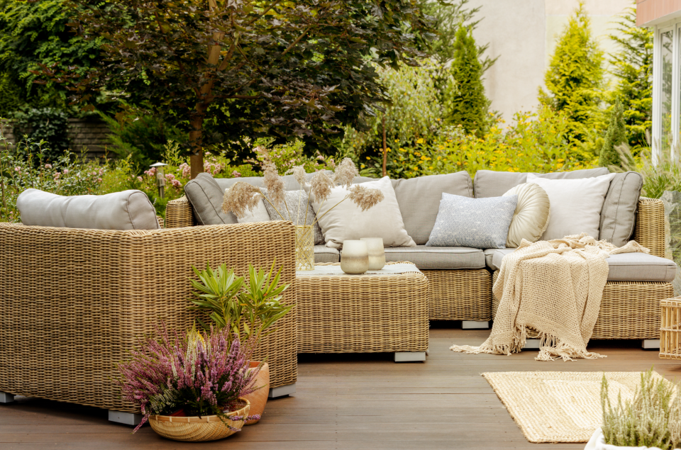 Wicker furniture on a wooden terrace of modern house