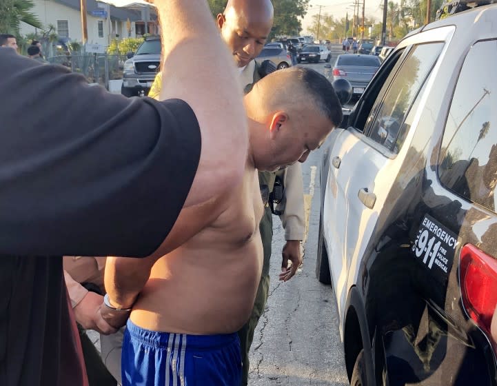 L.A. County Sheriff's deputies take Manuel Velasquez into custody after serving a search warrant on his home in East L.A. Velasquez, along with his son, Anthony Velasquez, are suspects in connection with three killings committed in East Los Angeles between 2014 and 2018.