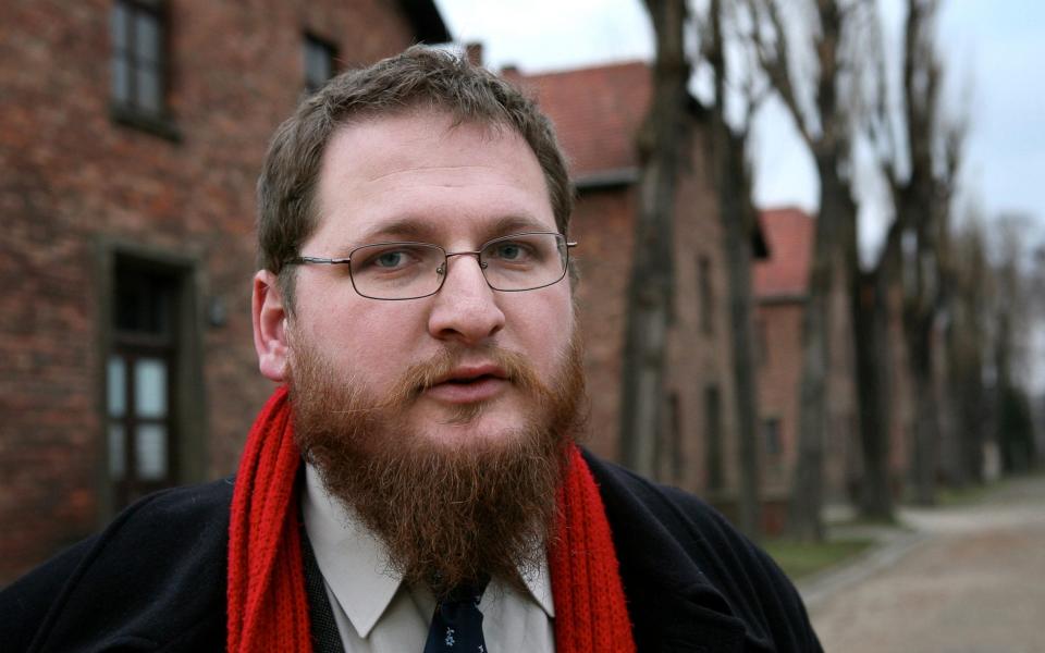 Piotr Cywinski poses in front of barracks in Auschwitz, the former Nazi death camp  - WOJTEK RADWANSKI/AFP/Getty Images