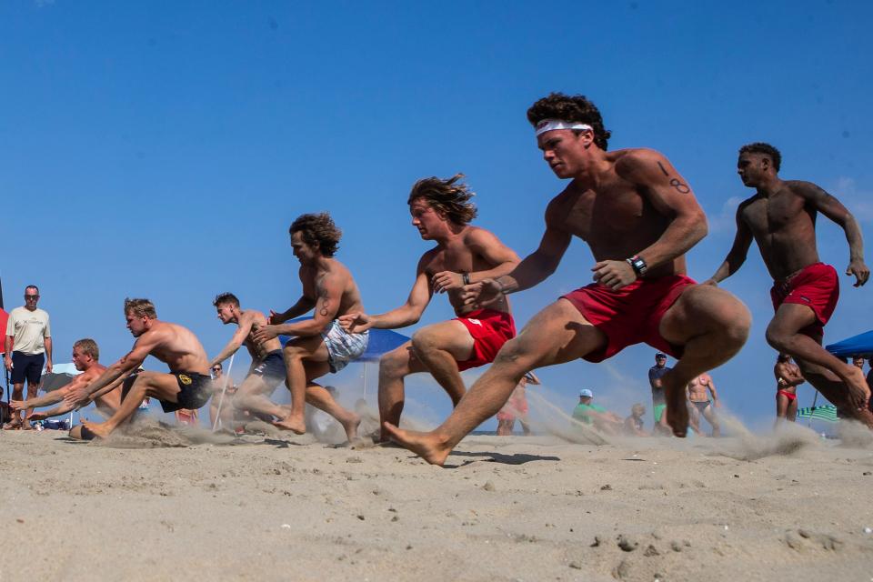 Lifeguards compete in the beach run race during the Mid-Atlantic Regional Lifeguard Championship at the Rehoboth Beach, Wednesday, July 12, 2023.
