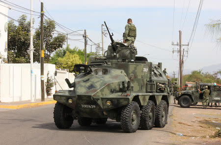 A soldier atop a vehicle is seen outside the Forensic Medical Service (SEMEFO) after the arrival of the body of Francisco Zazueta, also known as "Pancho Chimal," in Culiacan, in Mexico's northern Sinaloa state April 15, 2017. REUTERS/Jesus Bustamante